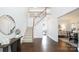 Bright foyer with hardwood floors, staircase with white railings, and decorative mirror at 6206 Glencairn Ct, Charlotte, NC 28269