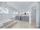 Spacious ensuite bathroom with dual vanity sinks, tub, and modern finishes at 6206 Glencairn Ct, Charlotte, NC 28269