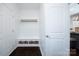 Mudroom features white shiplap and built-in bench seating with storage baskets at 6206 Glencairn Ct, Charlotte, NC 28269