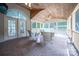 Cozy screened-in porch with brick flooring, comfortable seating, and a wood paneled ceiling with fans at 6206 Glencairn Ct, Charlotte, NC 28269