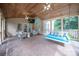Spacious screened-in porch featuring brick flooring, seating, daybed, and wood paneled ceilings with fans at 6206 Glencairn Ct, Charlotte, NC 28269