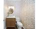 Powder room with vanity and decorative wallpaper at 6206 Glencairn Ct, Charlotte, NC 28269
