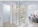 Modern tiled shower with glass enclosure, dual showerheads, and bench seating next to the main bedroom at 6206 Glencairn Ct, Charlotte, NC 28269
