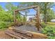 Beautiful backyard featuring a wooden pergola with a stone fire pit and a seating area at 632 Skyland N Dr, Mount Pleasant, NC 28124
