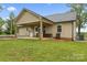 Cozy backyard featuring a covered porch, manicured lawn, and outdoor storage at 632 Skyland N Dr, Mount Pleasant, NC 28124