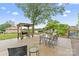 The backyard featuring a grill under a shelter, dining table, and a seating area, ideal for entertaining at 632 Skyland N Dr, Mount Pleasant, NC 28124