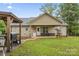 Cozy backyard featuring a covered porch, manicured lawn, and a grill perfect for entertaining at 632 Skyland N Dr, Mount Pleasant, NC 28124