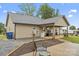 Home's backyard featuring a covered porch, a compact refrigerator, and a manicured lawn at 632 Skyland N Dr, Mount Pleasant, NC 28124