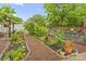 Landscaped backyard with a mulch path, lush greenery, and a fenced area, creating a serene outdoor space at 632 Skyland N Dr, Mount Pleasant, NC 28124