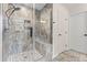 Modern bathroom featuring a glass shower with elegant tile and pebble flooring with a built in bench at 632 Skyland N Dr, Mount Pleasant, NC 28124