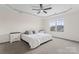 Bright bedroom featuring a white ceiling fan, two night stands, and a window with neighborhood view at 632 Skyland N Dr, Mount Pleasant, NC 28124