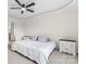 Bright bedroom featuring two white night stands and a large comfortable bed with decorative pillows at 632 Skyland N Dr, Mount Pleasant, NC 28124