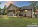 Home exterior showcasing a covered patio, lawn, and neutral siding under a twilight sky at 632 Skyland N Dr, Mount Pleasant, NC 28124