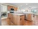 Bright kitchen features wood cabinets, stainless appliances, granite counters, and a center island with seating at 632 Skyland N Dr, Mount Pleasant, NC 28124