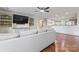 Open-concept living room featuring hardwood floors, built-in shelving, and a modern ceiling fan at 632 Skyland N Dr, Mount Pleasant, NC 28124