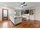 Bright living room with a decorative front door, hardwood floors and built-in shelving at 632 Skyland N Dr, Mount Pleasant, NC 28124