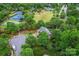 Aerial view of the community, including tennis courts, a playground, green spaces, and tree-lined streets at 6432 Morningsong Ln, Charlotte, NC 28269