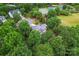Aerial view of a home with mature trees, a circular driveway, and neighborhood tennis courts at 6432 Morningsong Ln, Charlotte, NC 28269