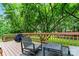 Back deck with outdoor seating area offering great views of a tree-lined yard at 6432 Morningsong Ln, Charlotte, NC 28269