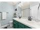 Charming bathroom with a double sink vanity, decorative wallpaper, and black and white patterned floor at 6432 Morningsong Ln, Charlotte, NC 28269