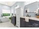Luxurious bathroom with dual vanities, a soaking tub, and modern fixtures at 6432 Morningsong Ln, Charlotte, NC 28269