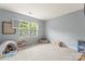 Spacious bedroom with neutral carpet, bright natural light, and lots of extra play space at 6432 Morningsong Ln, Charlotte, NC 28269