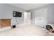 Neutral carpet in a well-lit room with modern decorations, a television, and a spacious closet at 6432 Morningsong Ln, Charlotte, NC 28269
