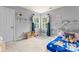 room offering natural light from corner windows and playful wall decor and blue curtains at 6432 Morningsong Ln, Charlotte, NC 28269