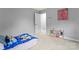 Bedroom featuring a bed with blue blanket and grey walls with white trim, and small decorative shelving at 6432 Morningsong Ln, Charlotte, NC 28269
