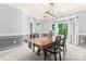 Bright dining room with large windows and stylish pendant lighting at 6432 Morningsong Ln, Charlotte, NC 28269