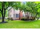 Back exterior of a home featuring a wooden deck, green lawn, and mature trees offering shade and privacy at 6432 Morningsong Ln, Charlotte, NC 28269
