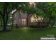 Charming home exterior with a brick chimney, wooden deck, and a beautifully landscaped backyard at 6432 Morningsong Ln, Charlotte, NC 28269