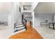 Open-concept foyer with staircase and hardwood floors leading to the living room at 6432 Morningsong Ln, Charlotte, NC 28269