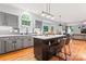 Bright kitchen with gray cabinets, white countertops, an island with seating, and stainless steel appliances at 6432 Morningsong Ln, Charlotte, NC 28269