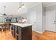 Bright kitchen featuring a large island and wood floors, adjacent to the dining area and living room at 6432 Morningsong Ln, Charlotte, NC 28269
