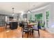 Bright eat-in kitchen features a center island, stainless steel appliances, and hardwood floors at 6432 Morningsong Ln, Charlotte, NC 28269