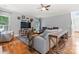 Well-lit living room with wood floors, neutral walls, and a cozy seating area with entertainment center at 6432 Morningsong Ln, Charlotte, NC 28269