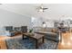 Open floorplan of the living room with hardwood floors and contemporary decor leading to the kitchen at 6432 Morningsong Ln, Charlotte, NC 28269