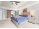 Well-lit main bedroom featuring a barn door, tray ceiling, and two windows at 6432 Morningsong Ln, Charlotte, NC 28269