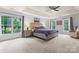 Spacious main bedroom with tray ceiling, lots of natural light, and carpet at 6432 Morningsong Ln, Charlotte, NC 28269