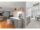 Home office with built-in desk, drawers, wood floors, and open to the living room at 6432 Morningsong Ln, Charlotte, NC 28269