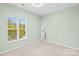 Comfortable bedroom with a window overlooking the backyard at 6443 Mallard View Ln, Charlotte, NC 28269