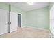 Bright bedroom featuring multiple doors for closets and storage at 6443 Mallard View Ln, Charlotte, NC 28269