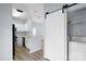 Contemporary kitchen design with granite countertops, a stylish barn door, and sleek appliances at 6443 Mallard View Ln, Charlotte, NC 28269