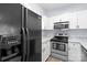 Contemporary kitchen with stainless steel appliances and a modern black refrigerator at 6443 Mallard View Ln, Charlotte, NC 28269