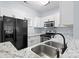 Modern kitchen featuring a black refrigerator and stainless steel appliances at 6443 Mallard View Ln, Charlotte, NC 28269