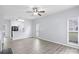 Open-concept living space with wood floors, a fireplace, and a view into the modern kitchen at 6443 Mallard View Ln, Charlotte, NC 28269