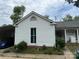 View of the home's side featuring white siding, updated windows, and a convenient covered parking area at 6507 Chewink Ct, Charlotte, NC 28227