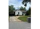Charming white home with a covered carport and neatly landscaped lawn on a partially cloudy day at 6507 Chewink Ct, Charlotte, NC 28227