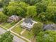 Expansive aerial view of a beautiful home surrounded by lush green trees and a well-manicured lawn at 7 Kings Mountain St, York, SC 29745